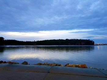 Scenic view of lake against sky at sunset