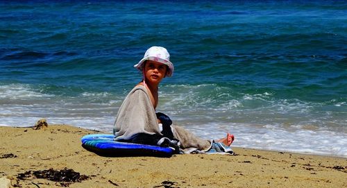 Full length of man sitting on beach