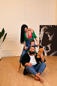 Young family ,father mother and son posing in photo studio