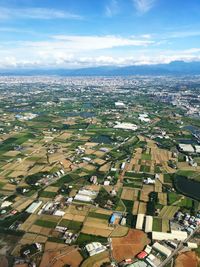 Aerial view of cityscape against blue sky