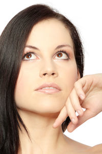 Close-up portrait of a beautiful young woman over white background
