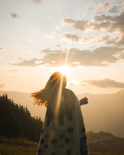 Woman against sky during sunset