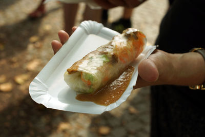 Cropped hand holding food