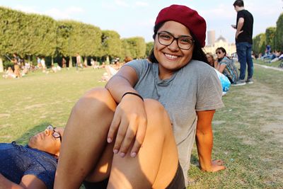 Portrait of smiling young couple kissing in park