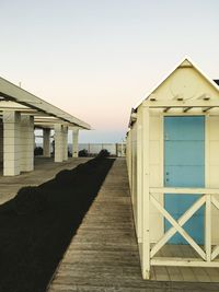 Beach cabins against clear sky