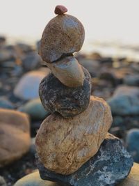 Stack of pebbles on rock at beach