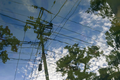 Low angle view of electricity pylon against sky