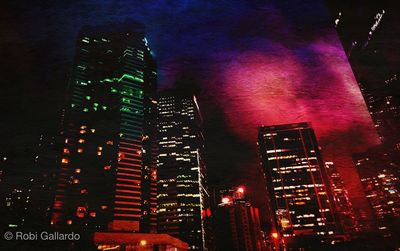 Low angle view of skyscrapers lit up at night