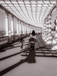 Rear view of women walking in corridor