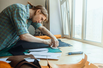 Woman working on table at home