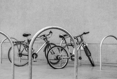 Bicycle on footpath against wall