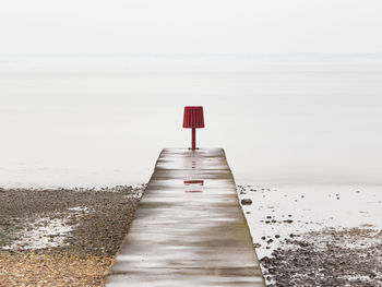 Lifeguard hut on beach against clear sky