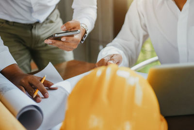 Midsection of doctor examining patient in hospital