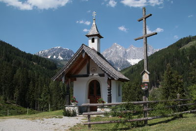 Traditional building by mountains against sky