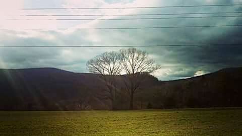 Scenic view of landscape against cloudy sky