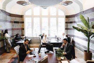 Multiracial female and male lawyers working at office