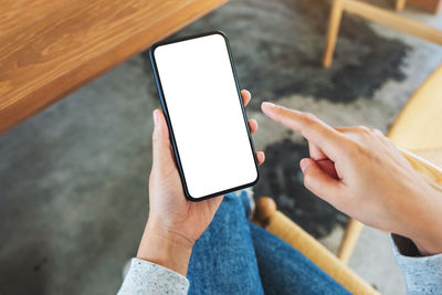 Midsection of man using mobile phone