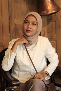 Portrait of a young woman sitting outdoors