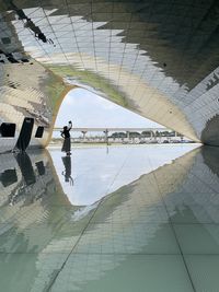 Rear view of man standing on bridge