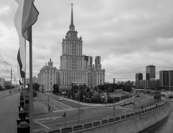 Buildings in city against cloudy sky