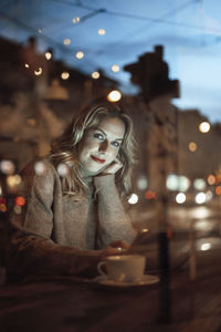 Portrait of woman with coffee cup in cafe