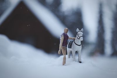 Snowman on snow covered landscape