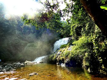 Scenic view of waterfall against sky