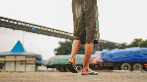 Low section of man standing outdoors