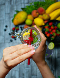 Cropped hand of woman holding drink