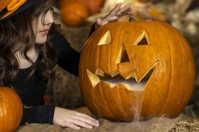 Woman holding jack o lantern