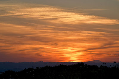 Scenic view of silhouette landscape against romantic sky at sunset