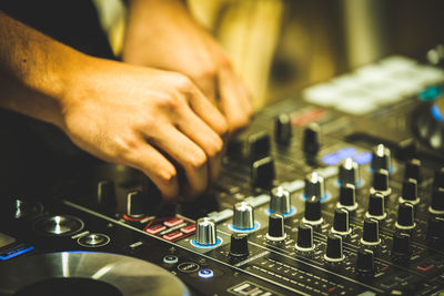 Cropped image of hand adjusting sound mixer