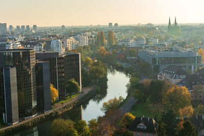 High angle view of river and buildings against clear sky