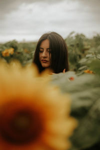 Young woman standing at sunflower farm