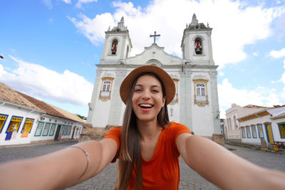 Girl takes self portrait in the historic center of sao joao del rei, minas gerais state, brazil