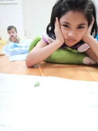 Portrait of a smiling young woman sitting at home