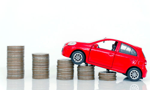 Red toy car against white background