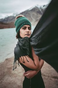 Portrait of man wearing hat standing on land