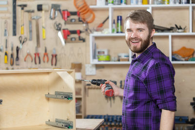 Portrait of smiling carpenter at workshop