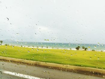 Raindrops on glass window of rainy season