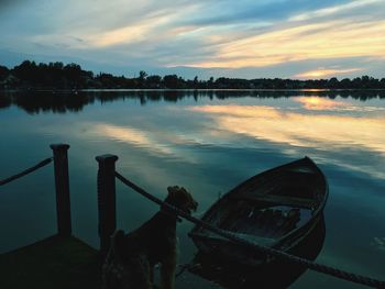 Boats in lake at sunset