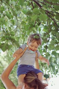 Full length of girl with plants against trees