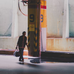 Full length of woman standing by railing