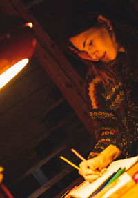 Low angle view of girl on book at home