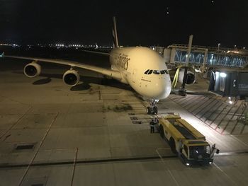 Airplane on airport runway at night