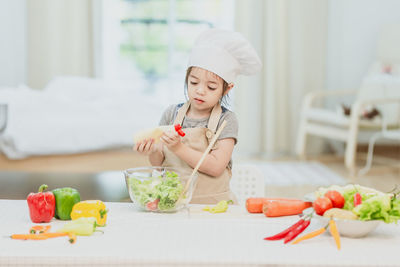 Girl holding food on table