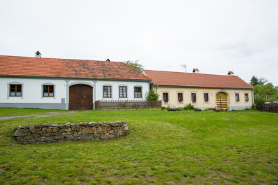 Houses on field against sky