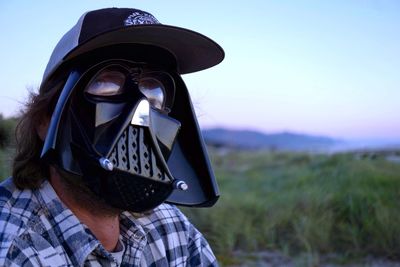 Close-up of man wearing protective mask at dusk