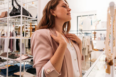 Side view of young woman in jewelry store