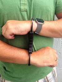 Midsection of man wearing handcuffs